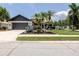 Charming home with a two-car garage, palm trees, and lush front yard landscaping at 11021 4Th E Ave, Bradenton, FL 34212
