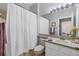 Bathroom with shower featuring a shower curtain, a mirror, and a single sink at 11208 Blue Sage Pl, Lakewood Ranch, FL 34202