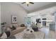 Bright living room featuring modern decor, a beige couch, and seamless transition to the open kitchen and dining area at 11208 Blue Sage Pl, Lakewood Ranch, FL 34202
