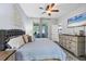 The main bedroom has a sliding glass door leading to an enclosed lanai and a doorway into the kitchen at 11208 Blue Sage Pl, Lakewood Ranch, FL 34202