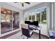 Office featuring many windows that provide natural light with an enclosed lanai visible through a sliding glass door at 11208 Blue Sage Pl, Lakewood Ranch, FL 34202