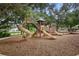 A playground with a slide and stairs on a mulch surface at Summerfield Park at 11208 Blue Sage Pl, Lakewood Ranch, FL 34202