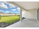Covered back porch overlooking a well maintained green backyard with a view of the horizon at 11427 Viani Ter, Palmetto, FL 34221
