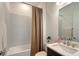 Well-lit bathroom featuring a vanity, sink, and bathtub with shower at 11427 Viani Ter, Palmetto, FL 34221