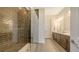 Bright bathroom with a large vanity, double sinks, and a luxurious walk-in shower at 11427 Viani Ter, Palmetto, FL 34221