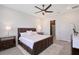 Primary bedroom featuring a large window, ceiling fan, and ensuite bathroom at 11427 Viani Ter, Palmetto, FL 34221