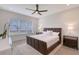 Comfortable bedroom with large window, ceiling fan, and neutral decor at 11427 Viani Ter, Palmetto, FL 34221