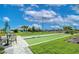 Bocce ball court with seating and a view of the lake and surrounding landscaping at 11427 Viani Ter, Palmetto, FL 34221