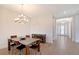 Cozy dining room with modern chandelier and a view of the entry hall at 11427 Viani Ter, Palmetto, FL 34221