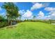 Spacious dog park featuring lush green grass, benches, and shady trees, providing a comfortable area for dogs to play and relax at 11427 Viani Ter, Palmetto, FL 34221