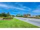 Artisan Lakes entrance with beautiful landscaping, signage, and a well-manicured road at 11427 Viani Ter, Palmetto, FL 34221