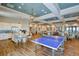 Spacious game room with a ping pong table, kitchen, and lounge area, ideal for entertaining and community gatherings at 11427 Viani Ter, Palmetto, FL 34221