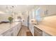 Spacious white kitchen with stainless steel appliances, large island, and lots of storage at 11427 Viani Ter, Palmetto, FL 34221