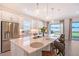Well-lit kitchen features a large island, stainless steel appliances, and sliding glass doors to the yard at 11427 Viani Ter, Palmetto, FL 34221