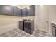 Convenient laundry room with modern washer and dryer units, and ample cabinet space at 11427 Viani Ter, Palmetto, FL 34221