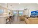 Beautiful open-concept kitchen and living room with stainless appliances and bar seating at 11427 Viani Ter, Palmetto, FL 34221