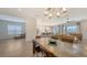 Open floor plan showcases living room, dining area, and kitchen with great natural light at 11427 Viani Ter, Palmetto, FL 34221