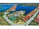Wide-angle aerial shot of the community showing pool, clubhouse, tennis courts, and residential area at 121 Porta Vecchio Bnd # 201, Nokomis, FL 34275