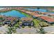 Beautiful aerial view of townhomes with terra cotta roofs lining a sparkling lake community at 121 Porta Vecchio Bnd # 201, Nokomis, FL 34275