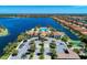 A stunning aerial view of the community clubhouse, pool, and surrounding lakefront homes at 121 Porta Vecchio Bnd # 201, Nokomis, FL 34275