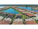 An aerial view showcasing beautiful waterfront homes in a well-planned community with scenic lakes and landscaping at 121 Porta Vecchio Bnd # 201, Nokomis, FL 34275