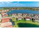 A panoramic aerial view of the community features a beautiful lake at 121 Porta Vecchio Bnd # 201, Nokomis, FL 34275