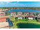 Stunning aerial view of homes surrounding a picturesque lake at 121 Porta Vecchio Bnd # 201, Nokomis, FL 34275