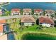 An aerial view of the townhome's backyard and nearby lake, with lush landscaping at 121 Porta Vecchio Bnd # 201, Nokomis, FL 34275
