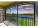 A screened balcony with stunning views of the lake and picturesque sunset at 121 Porta Vecchio Bnd # 201, Nokomis, FL 34275