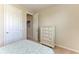 Bedroom showcasing a well-organized dresser, carpet flooring, and ample closet space at 121 Porta Vecchio Bnd # 201, Nokomis, FL 34275