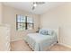 Inviting bedroom featuring a plush bed, dresser, ceiling fan, and natural light at 121 Porta Vecchio Bnd # 201, Nokomis, FL 34275