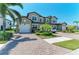 A spacious two-story home with a brick driveway, well-maintained landscaping, and a two-car garage at 121 Porta Vecchio Bnd # 201, Nokomis, FL 34275