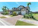 A spacious two-story home with a brick driveway, well-maintained landscaping, and a two-car garage at 121 Porta Vecchio Bnd # 201, Nokomis, FL 34275