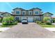 A spacious two-story home with a brick driveway, well-maintained landscaping, and a two-car garage at 121 Porta Vecchio Bnd # 201, Nokomis, FL 34275