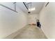 Spacious garage with concrete walls, overhead lighting, and an automatic door at 121 Porta Vecchio Bnd # 201, Nokomis, FL 34275