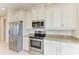 Kitchen featuring stainless steel appliances and granite countertops, with white cabinets at 121 Porta Vecchio Bnd # 201, Nokomis, FL 34275