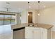 Kitchen island featuring white cabinets, granite countertops and stainless steel dishwasher with a view of the water at 121 Porta Vecchio Bnd # 201, Nokomis, FL 34275