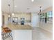 Bright kitchen featuring stainless steel appliances, granite countertops, and an island with pendant lights at 121 Porta Vecchio Bnd # 201, Nokomis, FL 34275