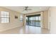 Bright living room features a sliding glass door leading to a screened lanai with pond views at 121 Porta Vecchio Bnd # 201, Nokomis, FL 34275