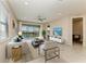 Bright living room with stylish furniture, neutral tones, tile flooring, and a lake view at 121 Porta Vecchio Bnd # 201, Nokomis, FL 34275