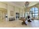 Stunning lobby with travertine floors, stone accents, chandelier, water view and seating area at 121 Porta Vecchio Bnd # 201, Nokomis, FL 34275