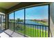 Screened-in lanai offers views of a pond and surrounding community at 121 Porta Vecchio Bnd # 201, Nokomis, FL 34275