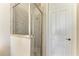 Shower with gray tile, a built-in bench, and a glass door, complemented by a white door at 121 Porta Vecchio Bnd # 201, Nokomis, FL 34275