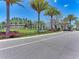 Toscana Isles community entrance with palm trees, landscaping and a monument sign at 121 Porta Vecchio Bnd # 201, Nokomis, FL 34275