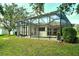 Spacious backyard showcasing a screened-in pool, patio, and lush greenery at 12358 Lavender Loop, Bradenton, FL 34212