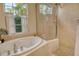 Spacious bathroom featuring soaking tub with jets and a glass-enclosed shower at 12358 Lavender Loop, Bradenton, FL 34212