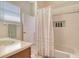 Bright bathroom featuring a tub with shower and decorative tile niche at 12358 Lavender Loop, Bradenton, FL 34212