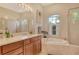 Bright bathroom features double sinks, a soaking tub, and a glass-enclosed shower at 12358 Lavender Loop, Bradenton, FL 34212