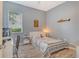 Serene bedroom features neutral tones, a comfy bed and natural light at 12358 Lavender Loop, Bradenton, FL 34212