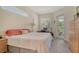Bright bedroom with a desk area, wood-look floors, and access to an outdoor balcony at 12358 Lavender Loop, Bradenton, FL 34212